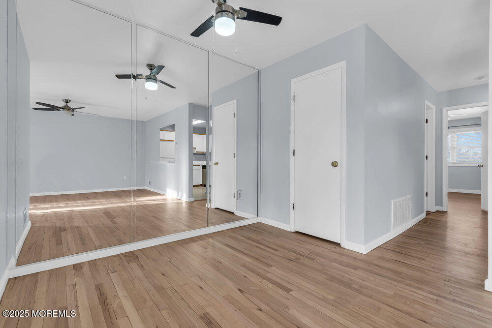 3403 Bridge Avenue, Unit 13 Point Pleasant, NJ 08742 - Photo 4 of 27 wooden floor in an empty room with a window