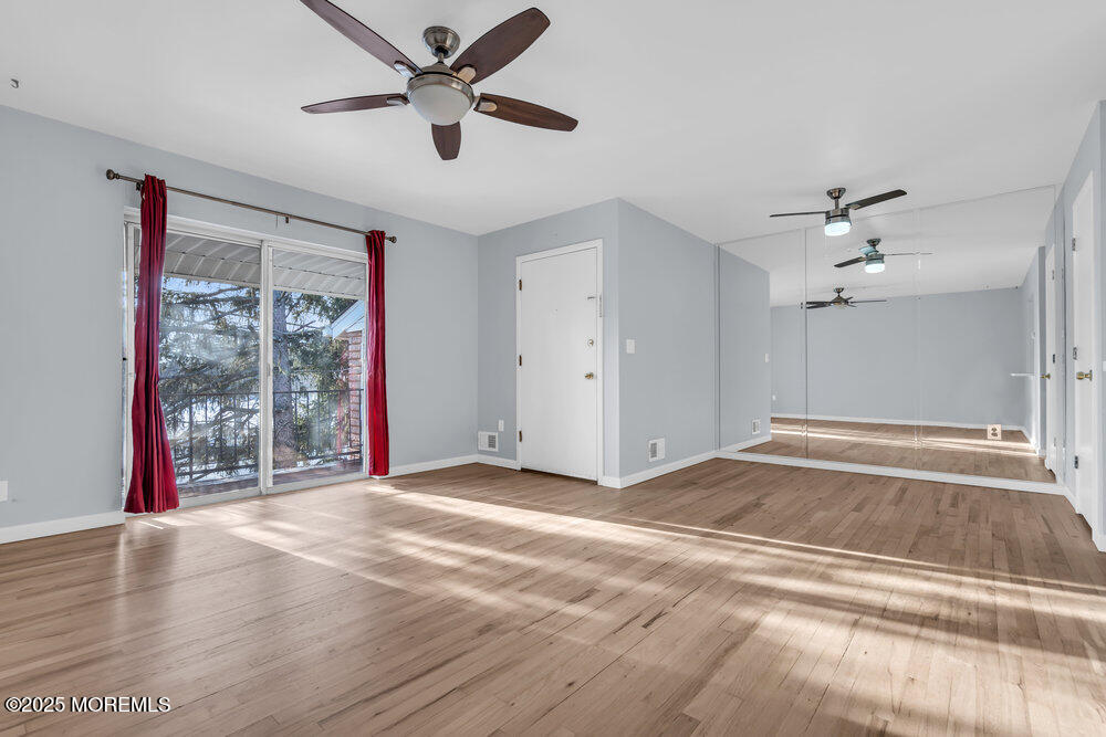3403 Bridge Avenue, Unit 13 Point Pleasant, NJ 08742 - Photo 6 of 27 a view of an empty room with a window and a ceiling fan