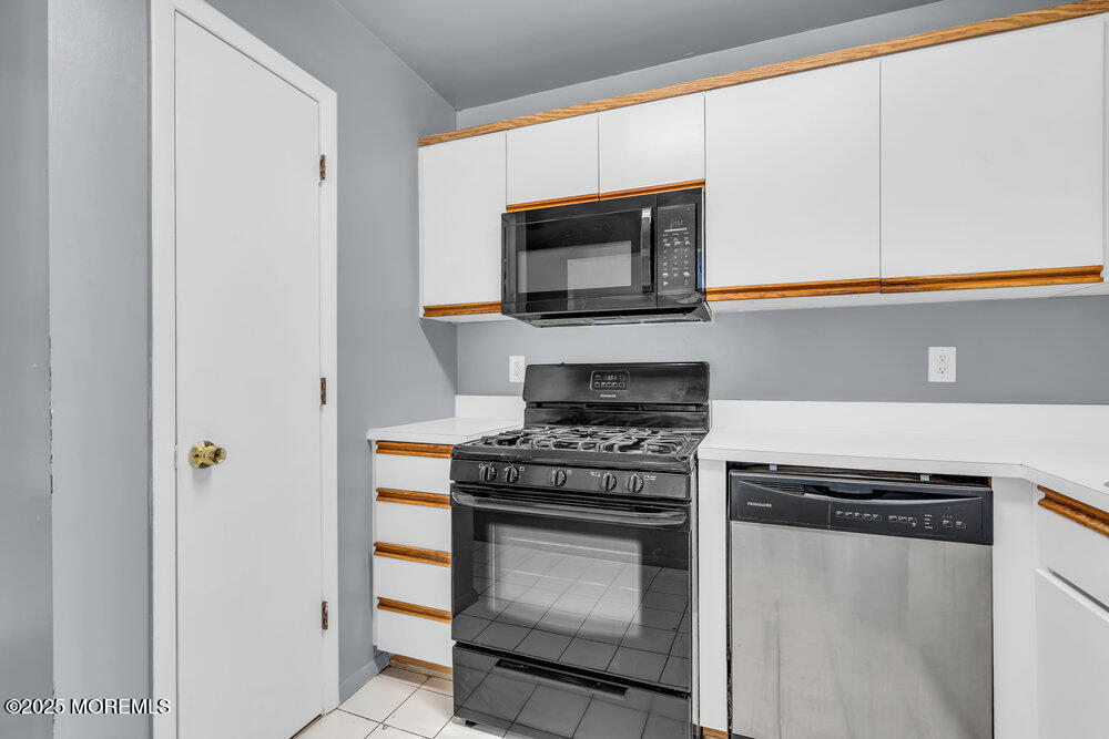 3403 Bridge Avenue, Unit 13 Point Pleasant, NJ 08742 - Photo 8 of 27 a kitchen with a stove and a microwave
