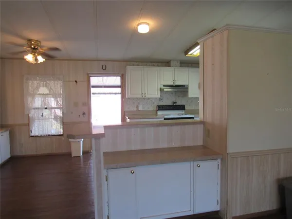 a kitchen with stainless steel appliances a refrigerator sink and cabinets