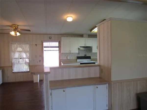 a bathroom with a granite countertop sink mirror and window