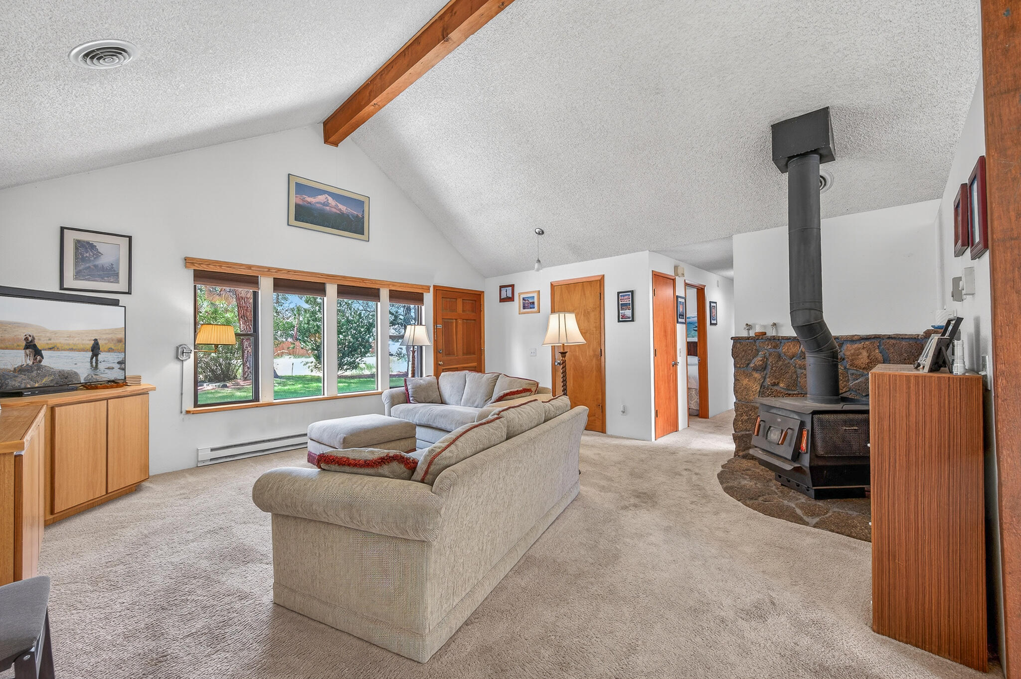 60866 Brosterhous Road Bend, OR 97702 - Photo 16 of 41 a living room with furniture and a flat screen tv