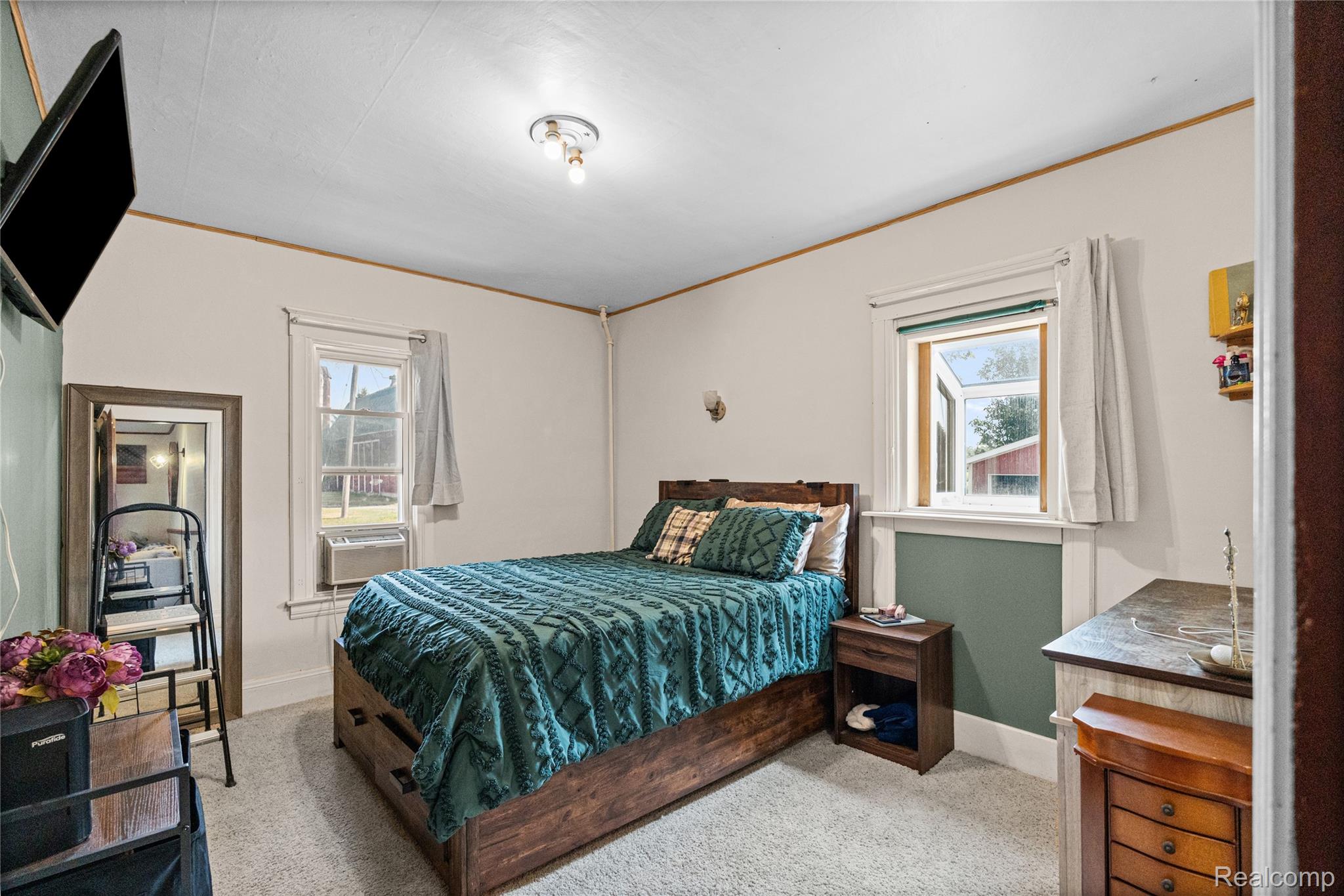 1175 South Morrish Road Flint, MI 48532 - Photo 24 of 72 Carpeted bedroom featuring white walls with wood trim accents and a partial accent wall in green