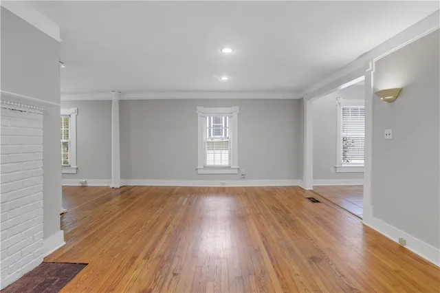 wooden floor in an empty room with a window