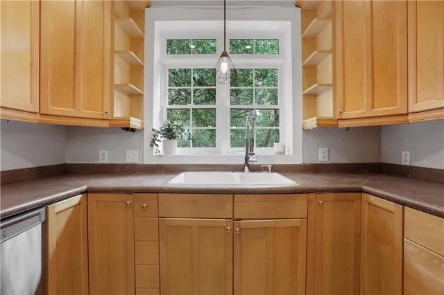 a kitchen with granite countertop cabinets and window