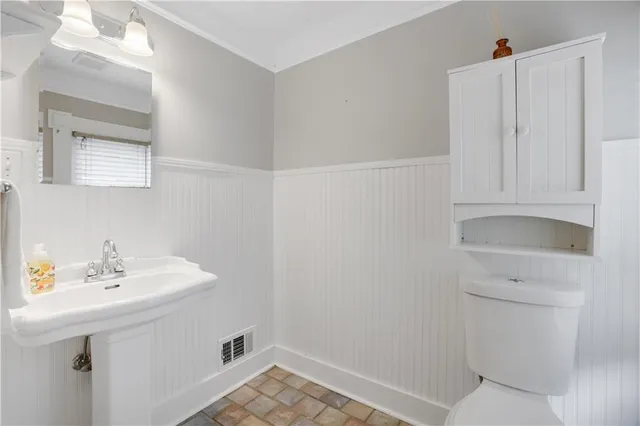 a bathroom with a sink a toilet and vanity