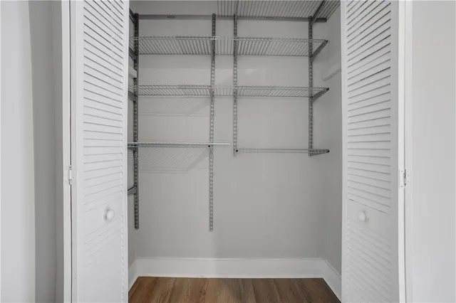 a view of walk in closet with empty racks