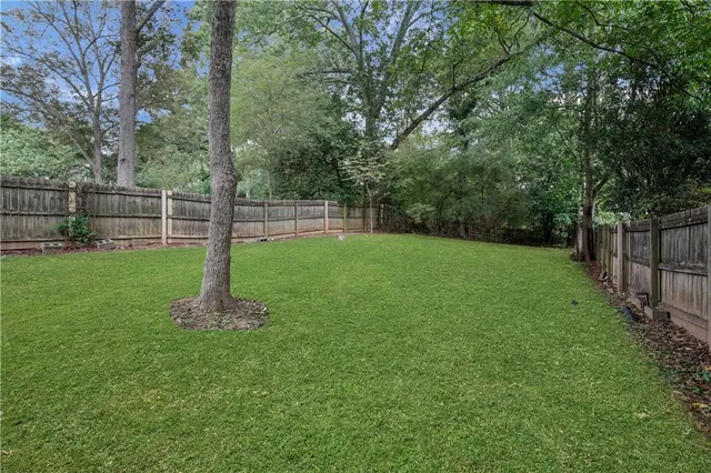 a view of a yard with a wooden fence