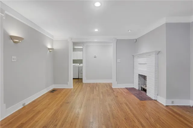 wooden floor in an empty room with a fireplace