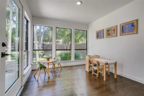 a dining room with furniture a chandelier and wooden floor