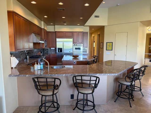 a living room with furniture and floor to ceiling windows
