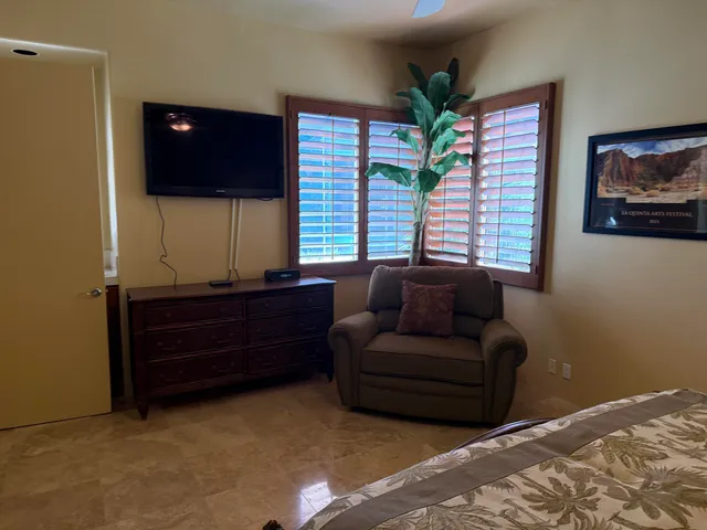 a view of a patio with table and chairs and potted plants