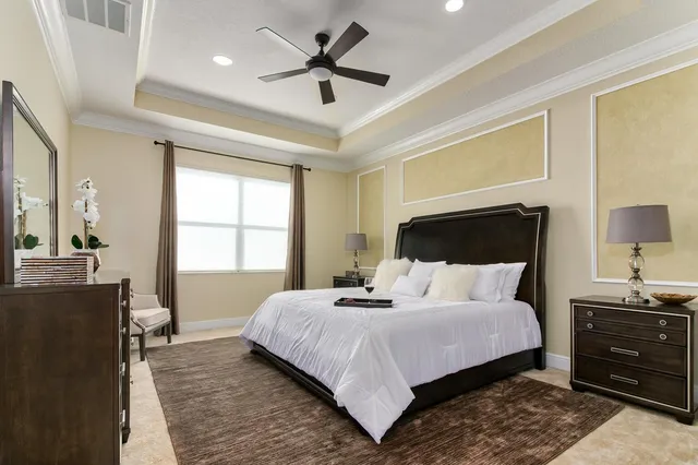 a bedroom with a bed and a chandelier