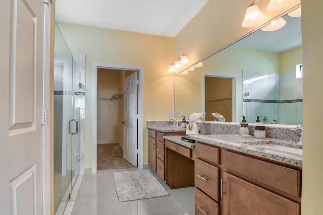 a bathroom with a granite countertop sink mirror and double
