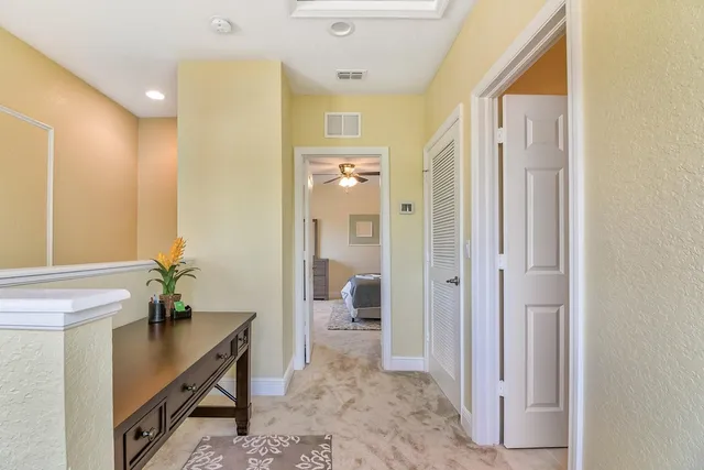 a hallway with beautiful frames and painted walls
