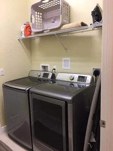 a utility room with a sink and wooden floor