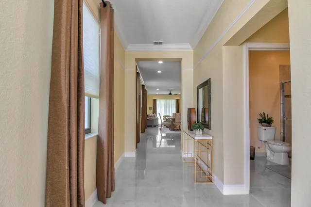 a view of a hallway with furniture and a livingroom view