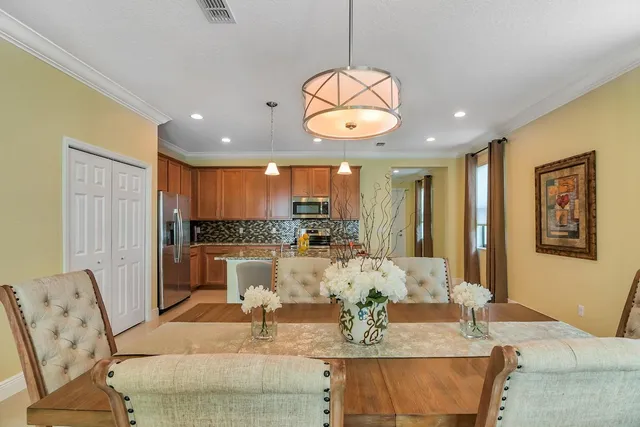 a large kitchen with a table and chairs