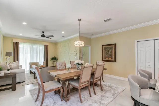 a dining room with furniture window and wooden floor