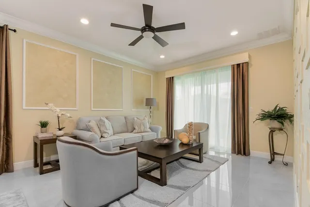 a living room with furniture a ceiling fan and a window