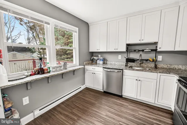 a kitchen with a sink window and cabinets