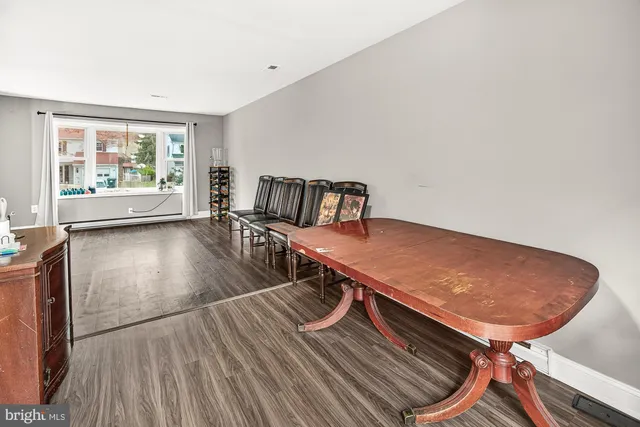 a view of a room with furniture and wooden floor