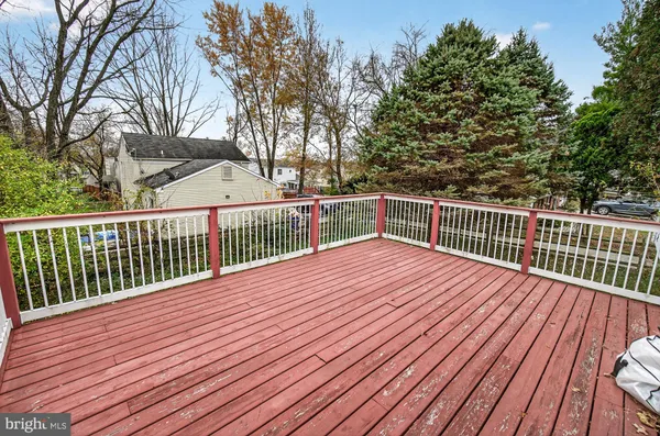 a balcony with wooden floor and trees