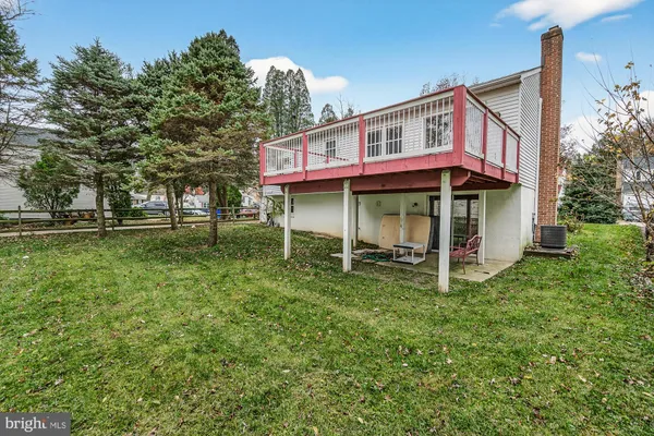 a view of a house with a yard balcony and sitting area