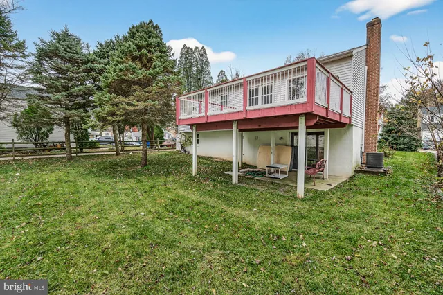 a view of a house with a yard balcony and sitting area