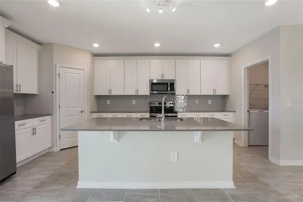 a large kitchen with white cabinets