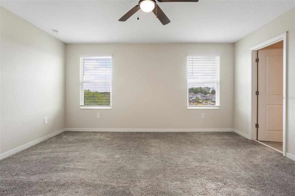 2932 Muller Oak Loop Ocoee, FL 34761 - Photo 15 of 32 an empty room with windows and fan