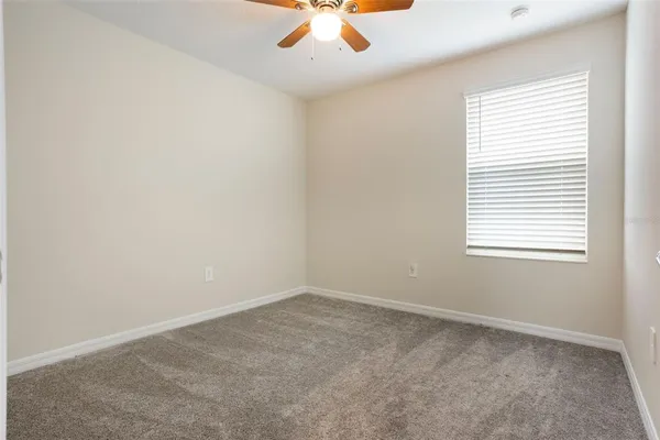 an empty room with windows and closet