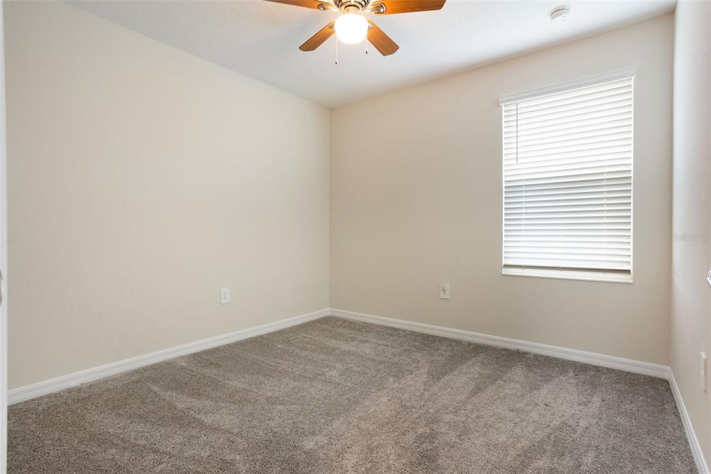 2932 Muller Oak Loop Ocoee, FL 34761 - Photo 19 of 32 an empty room with a window and a fan