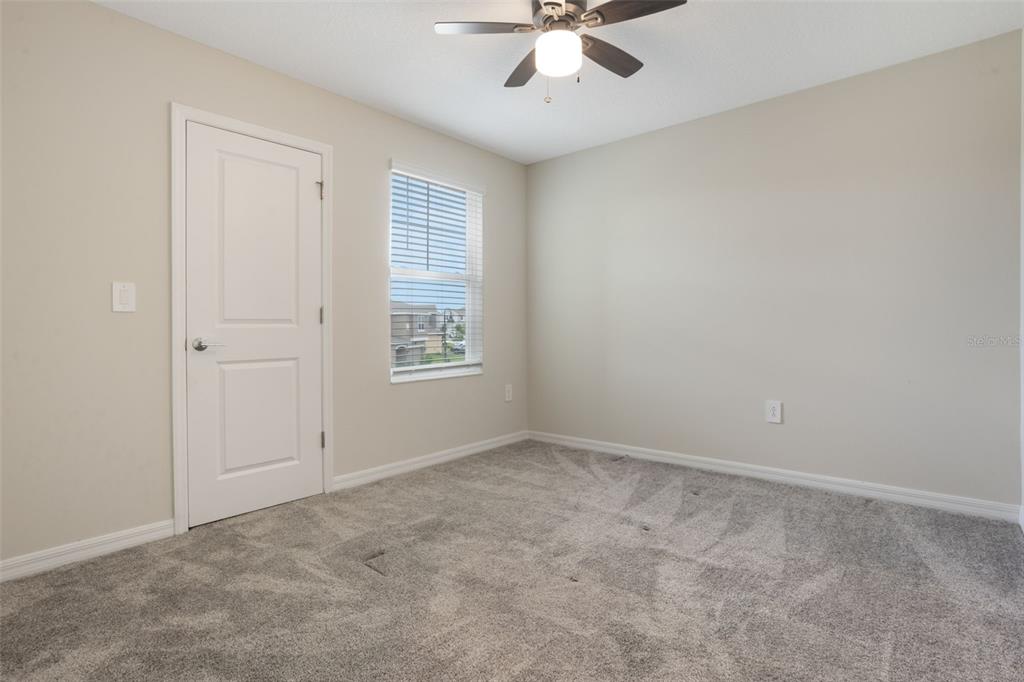 2932 Muller Oak Loop Ocoee, FL 34761 - Photo 21 of 32 an empty room with windows and fan