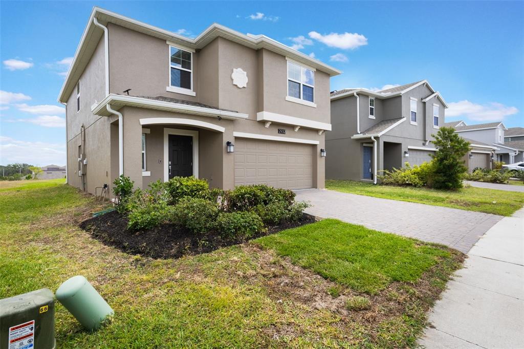 2932 Muller Oak Loop Ocoee, FL 34761 - Photo 3 of 32 a front view of a house with a garden