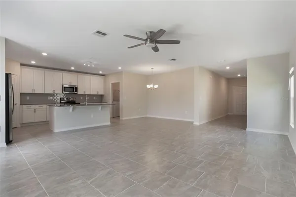 a view of a kitchen with a sink and a refrigerator