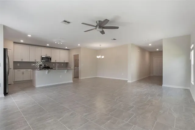 a view of a kitchen with a sink and a refrigerator