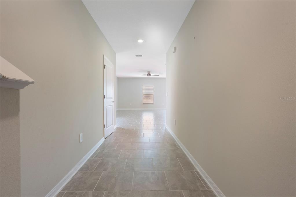 2932 Muller Oak Loop Ocoee, FL 34761 - Photo 5 of 32 a view of a hallway with wooden floor