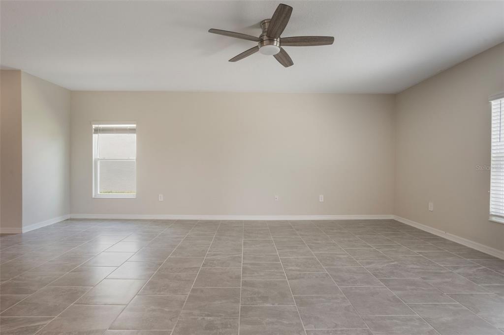 2932 Muller Oak Loop Ocoee, FL 34761 - Photo 7 of 32 an empty room with a ceiling fan and window