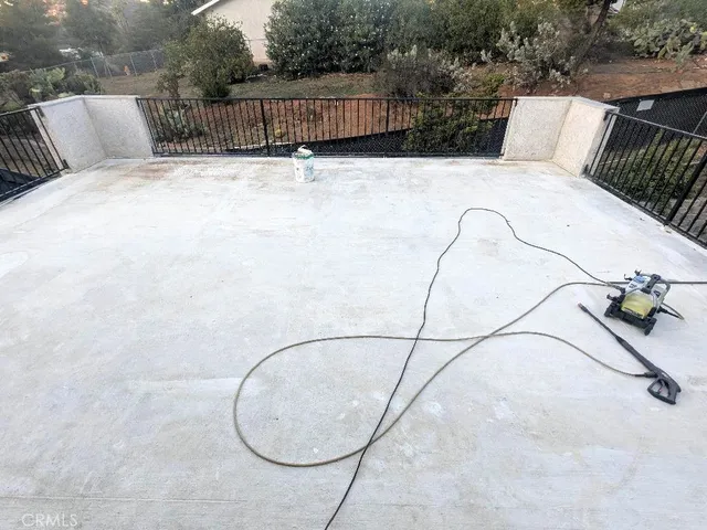 a view of a balcony with wooden floor and fence