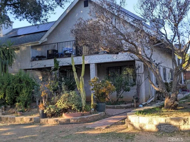 a view of a house with yard and sitting area