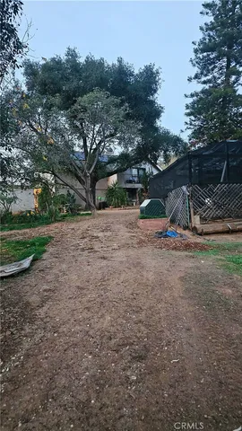 a view of a town with barn house in the background