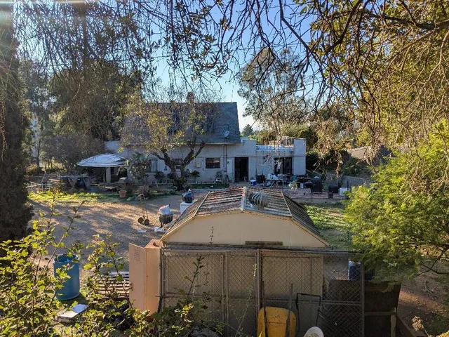 a view of a patio with table and chairs under an umbrella