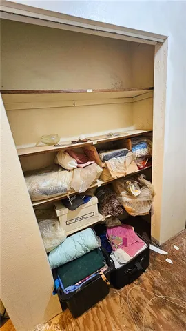 a kitchen with stainless steel appliances kitchen island granite countertop a dining table chairs and a refrigerator