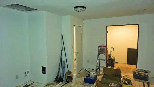 a view of a hallway with dining area and glass door