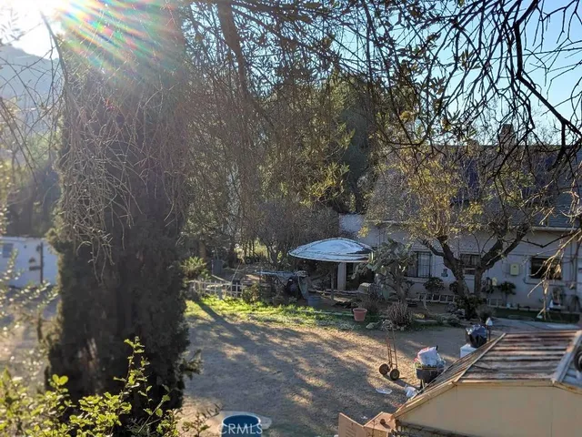 a view of outdoor space with seating area and trees