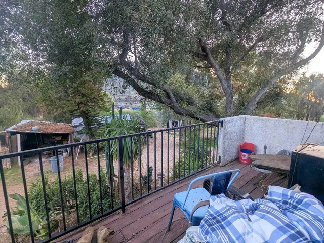 a roof deck with table and chairs under an umbrella