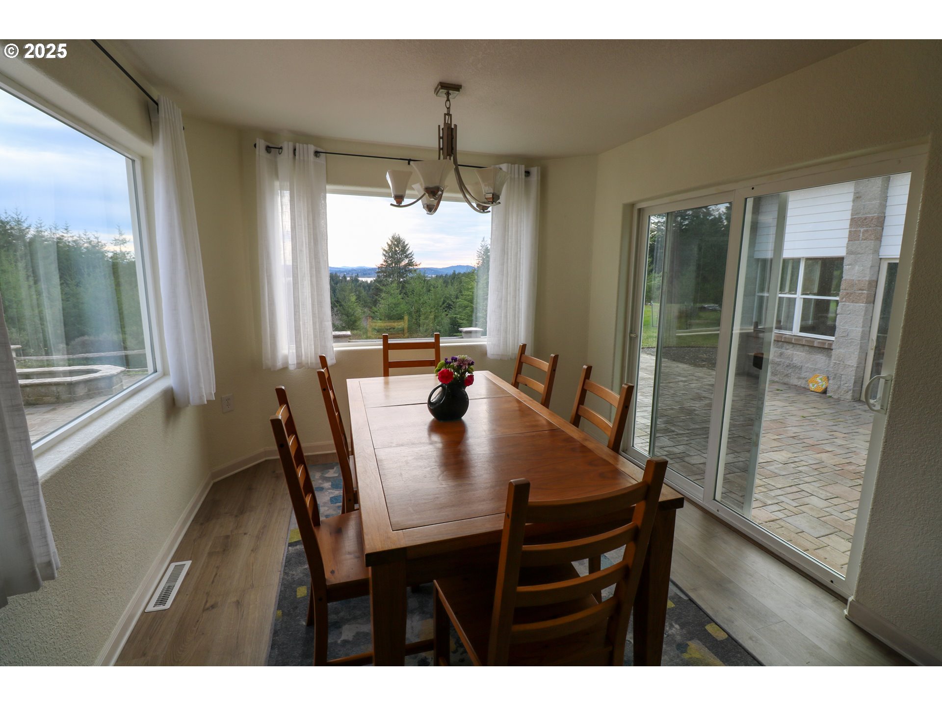 94088 Kirkendall Lane North Bend, OR 97459 - Photo 14 of 46 a view of a dining room with furniture window and wooden floor