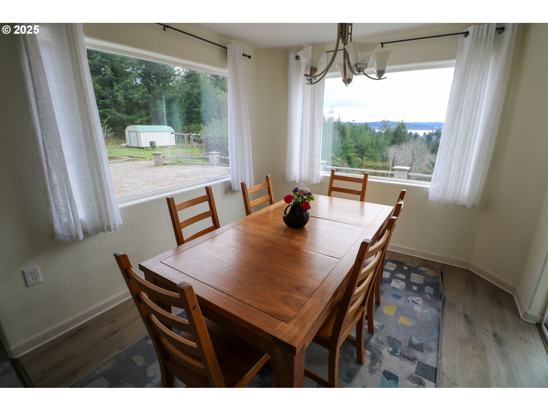 94088 Kirkendall Lane North Bend, OR 97459 - Photo 16 of 46 a view of a dining room with furniture and wooden floor