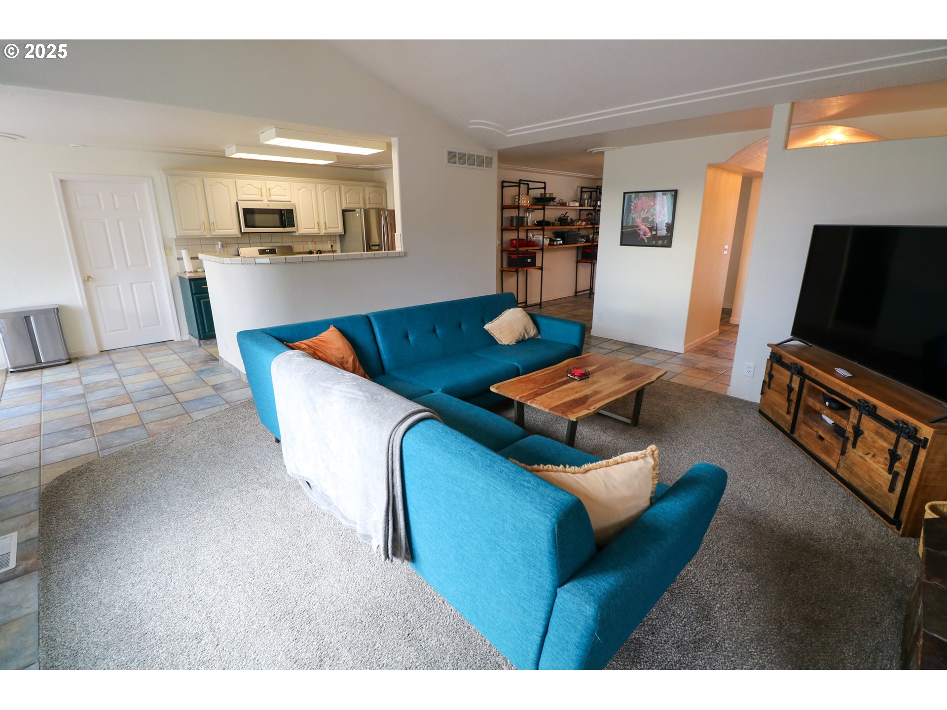 94088 Kirkendall Lane North Bend, OR 97459 - Photo 18 of 46 a living room with furniture and a flat screen tv
